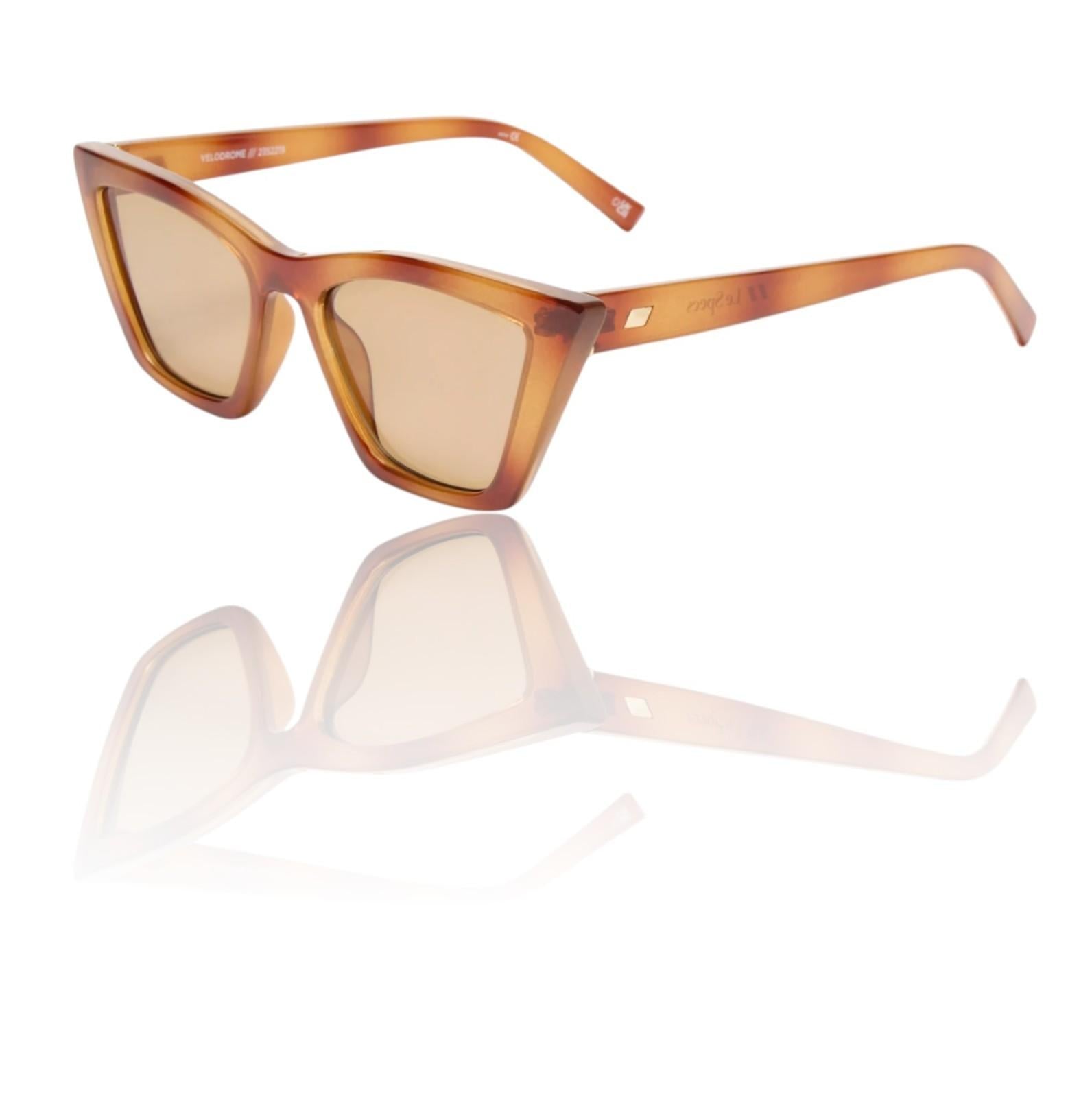 Sunglasses with tortoiseshell frame and brown lenses on a white background