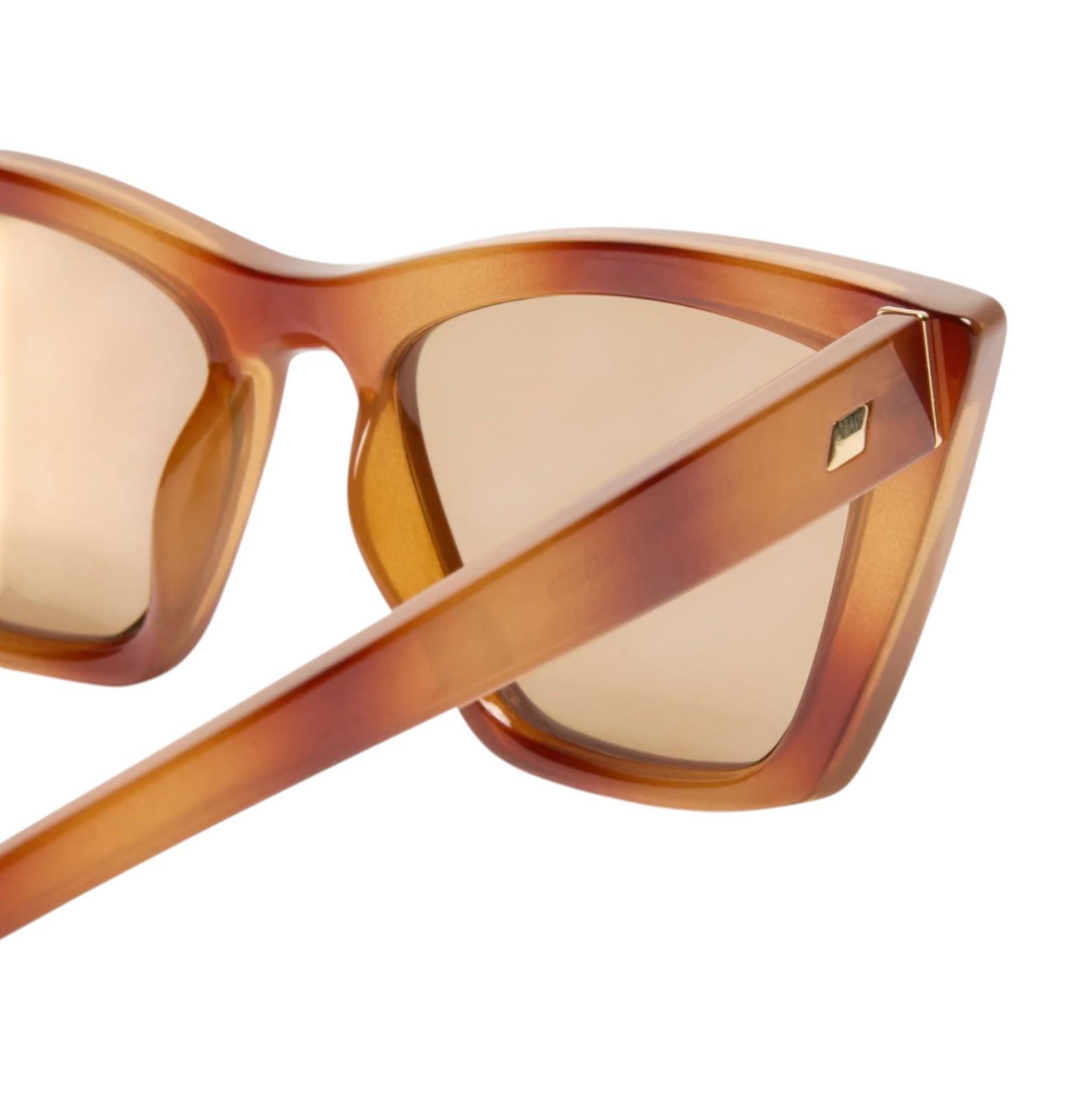 Brown sunglasses with a tortoiseshell frame on a white background