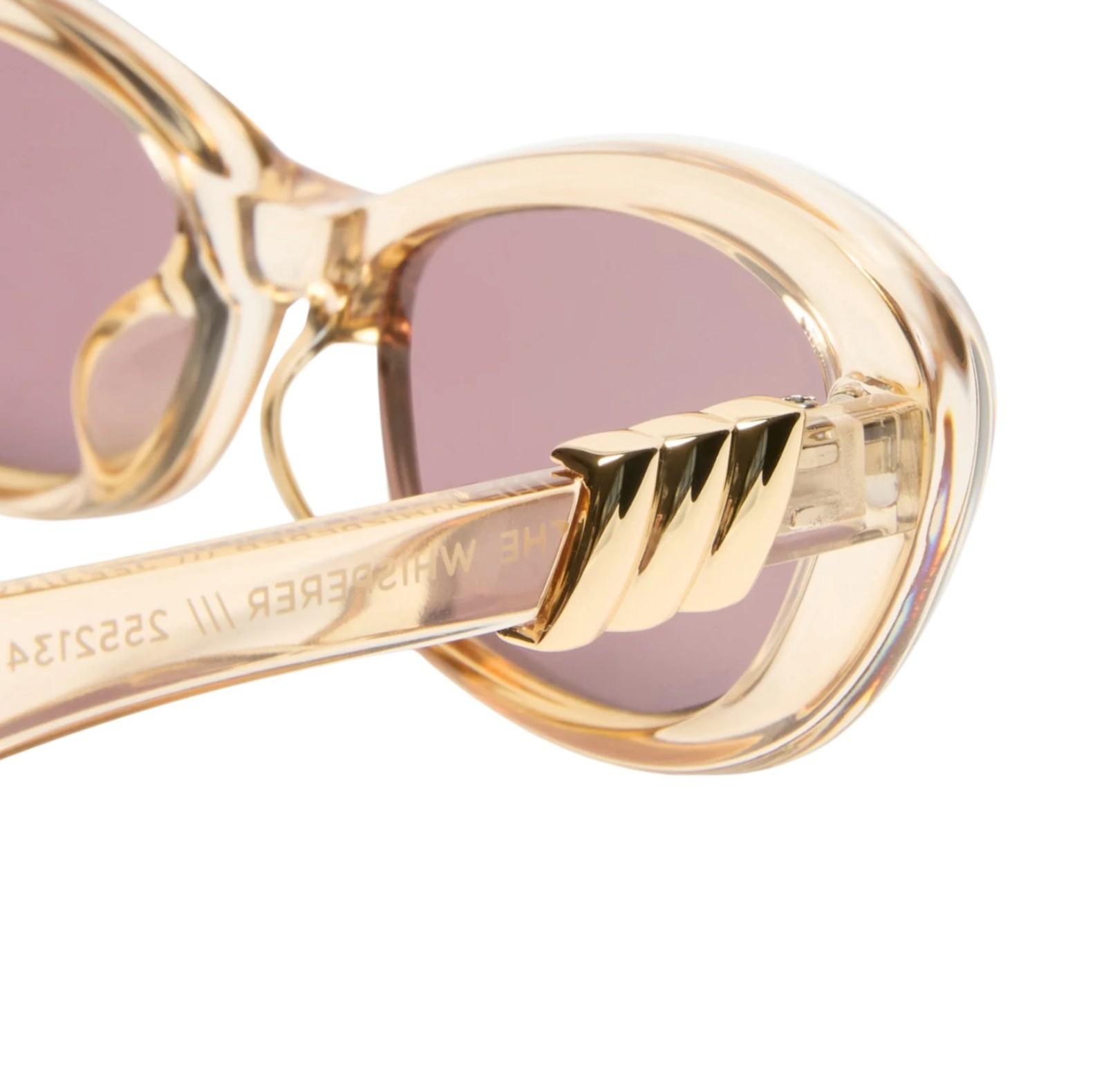 Gold sunglasses with pink lenses on a white background