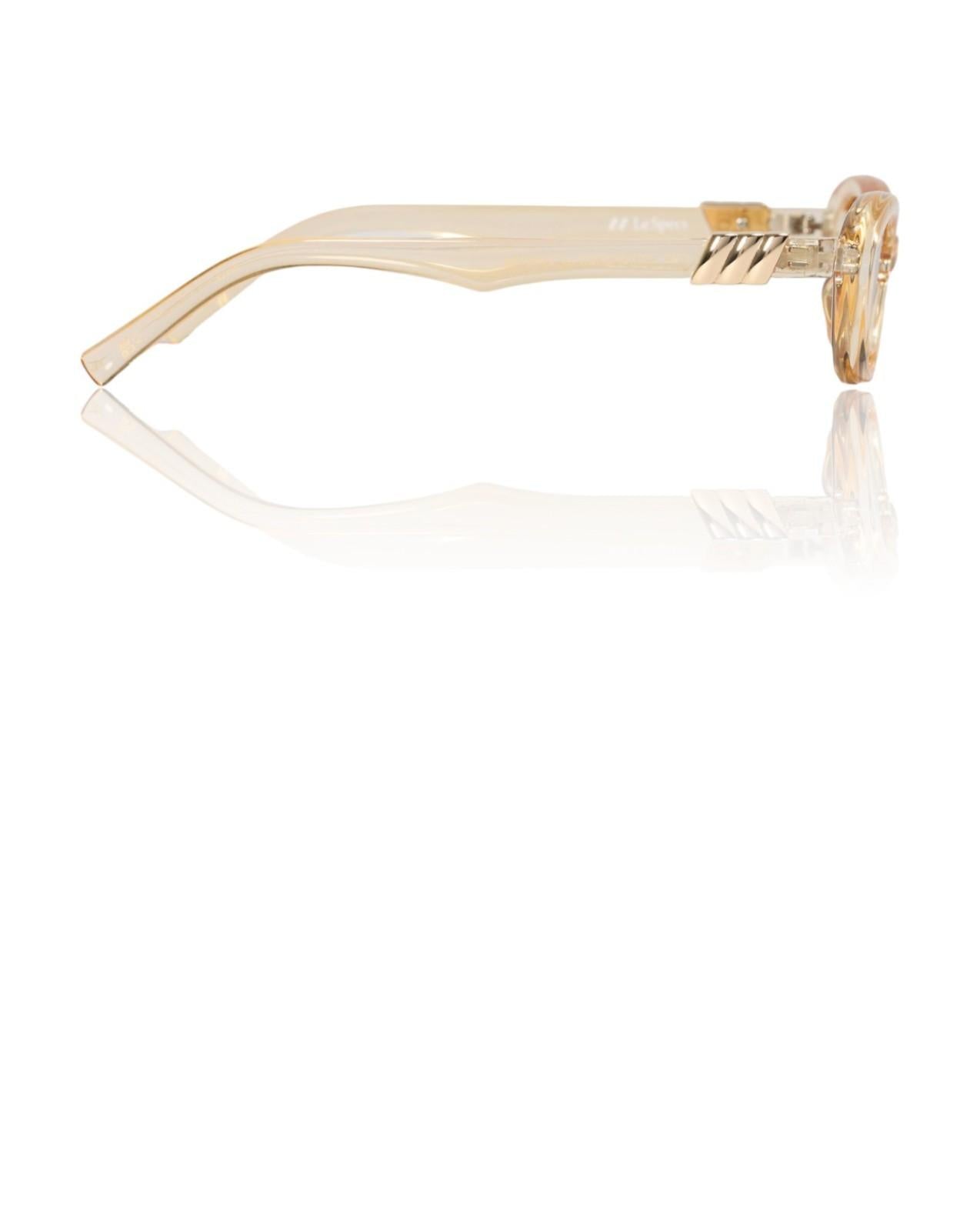 Clear eyeglasses with gold frame on a white background