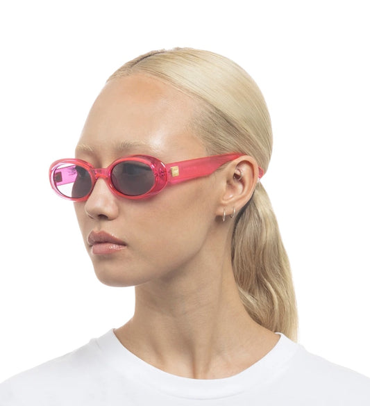 Person wearing red sunglasses with a white background