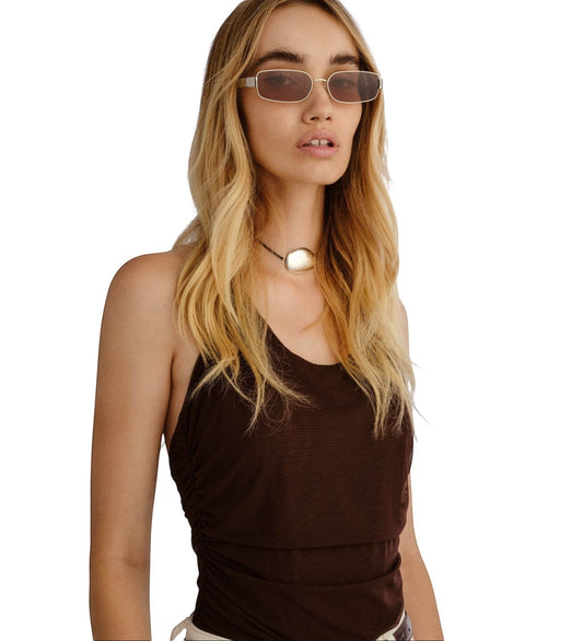 Model wearing Naked Pear LuvLou The Ryan rectangular silver metal sunglasses with khaki green lenses