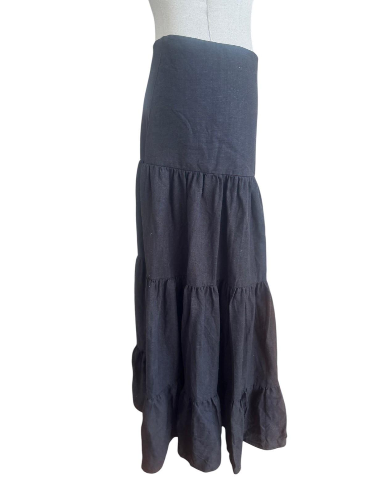 Dark gray tiered skirt on a mannequin against a white background