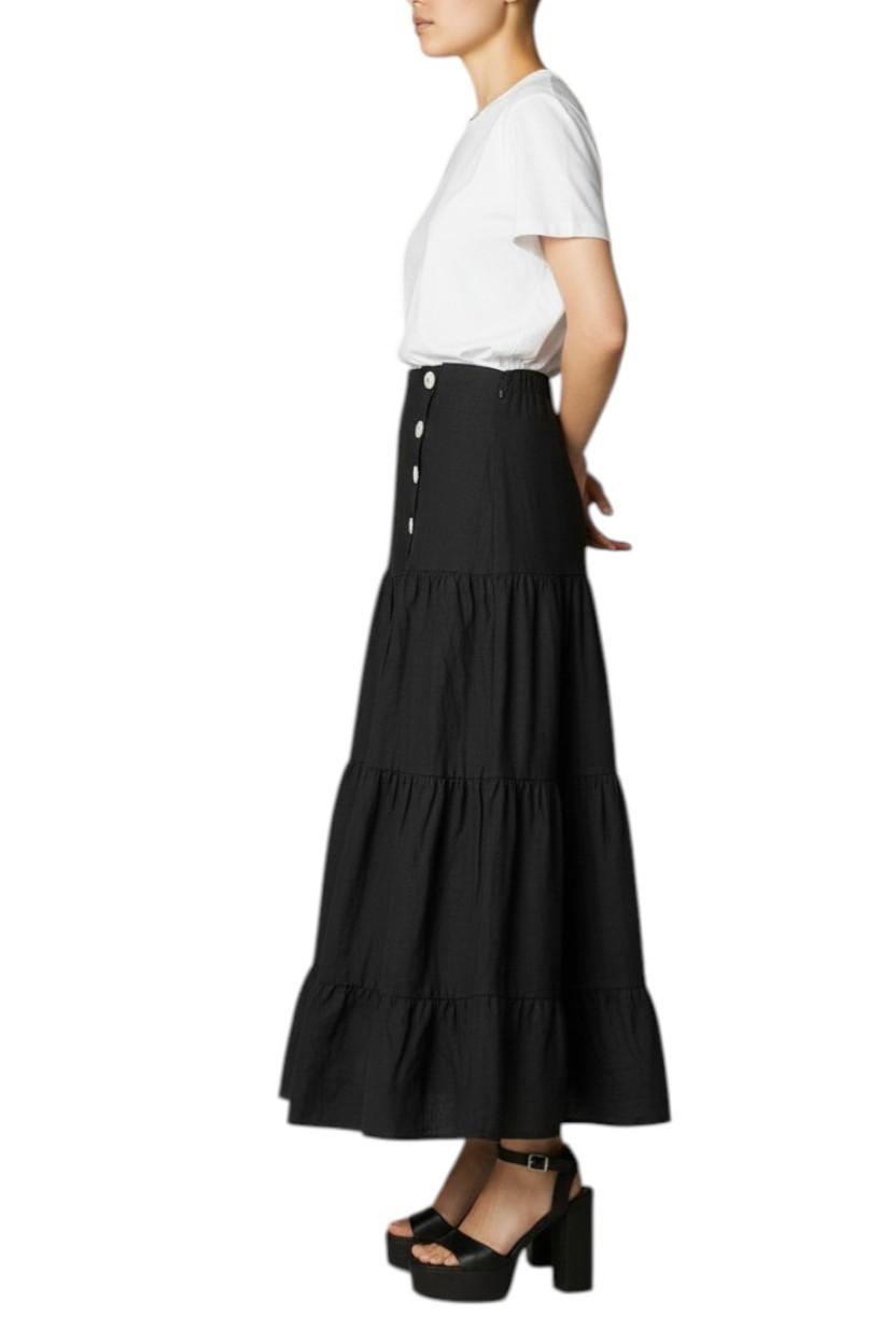 AI generated image of Woman wearing a black tiered skirt with buttons on a white background