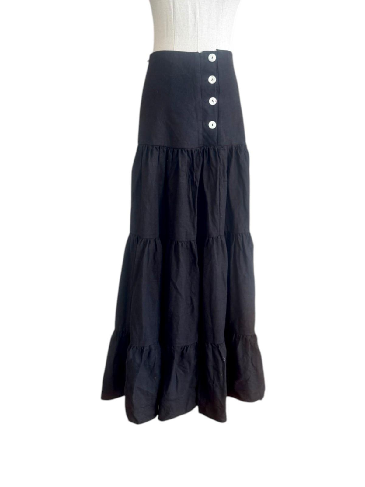 Black tiered skirt on a mannequin against a white background