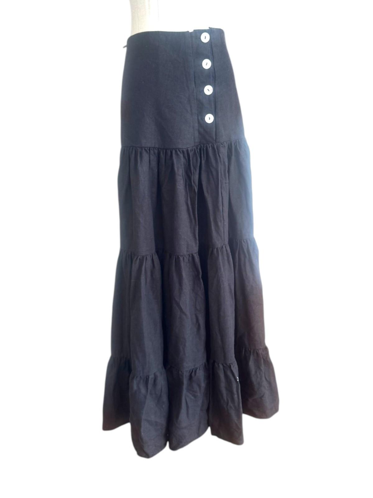 Black tiered skirt with button details on a white background