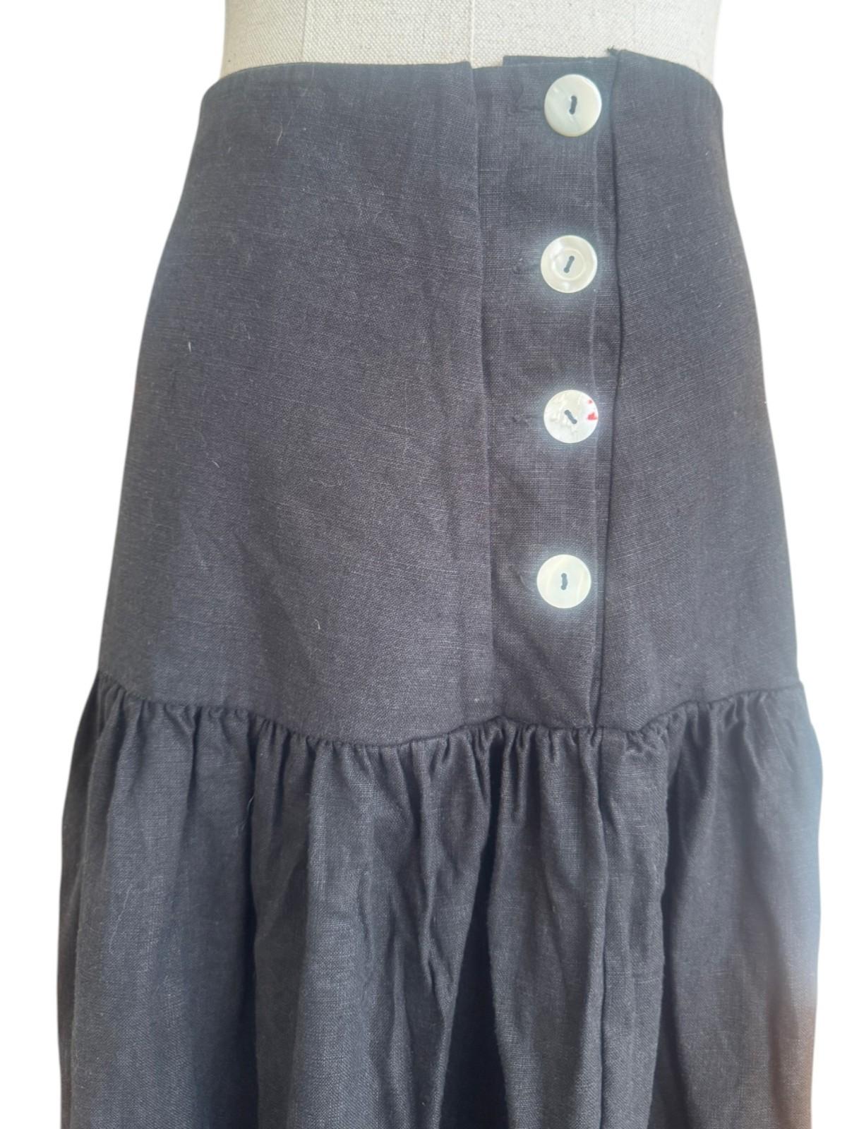 Gray skirt with button details on a mannequin against a white background