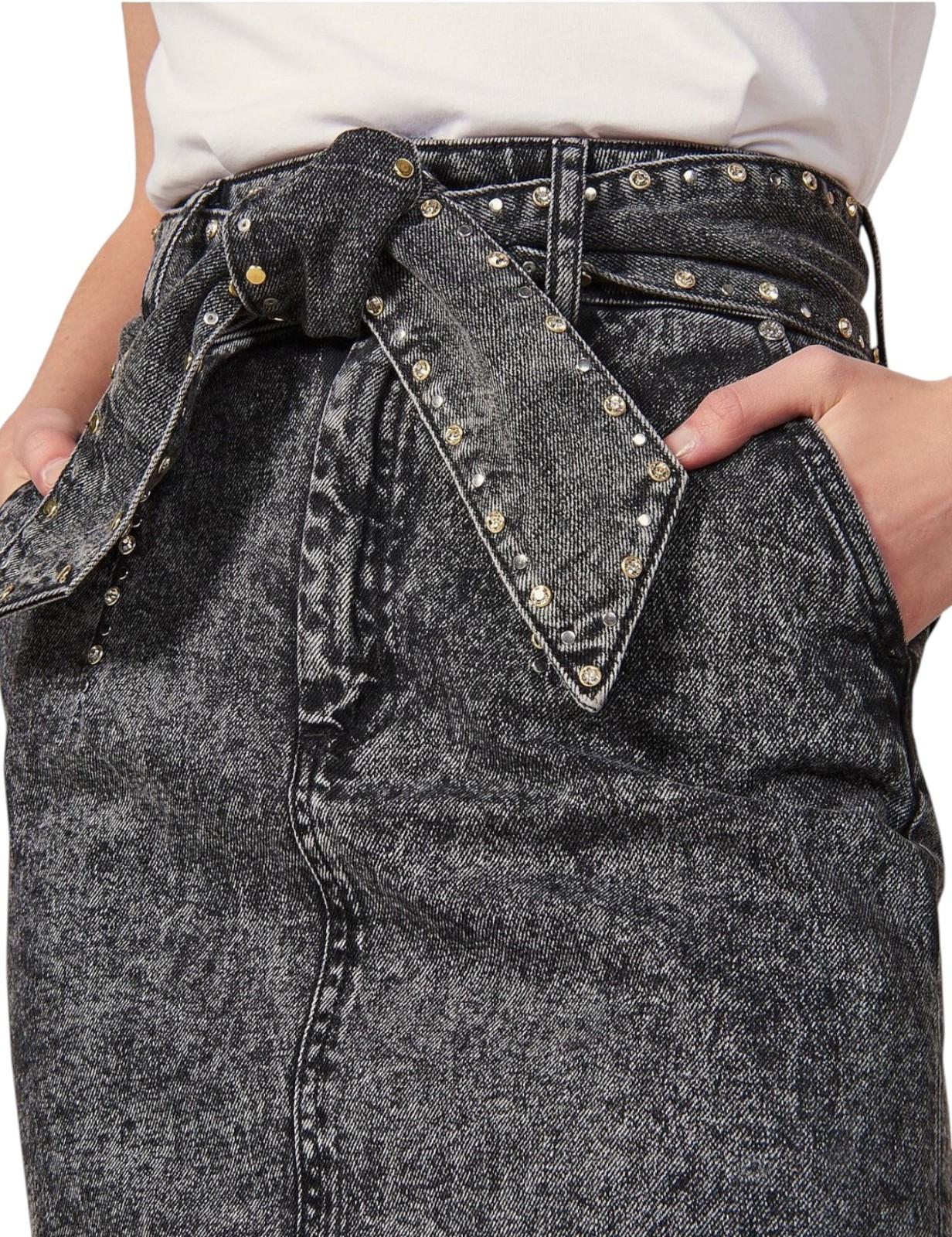 Close-up of black jeans with studded details on a white background
