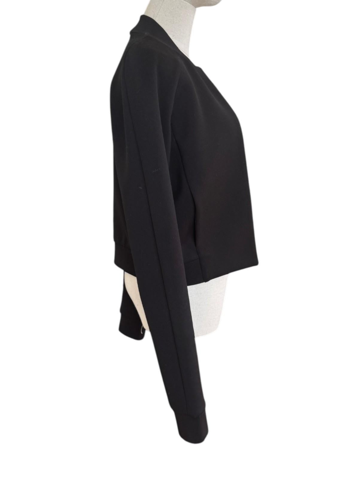 Naked Pear T by Alexander Wang black neoprene bomber jacket on a mannequin, side view showing mock collar.