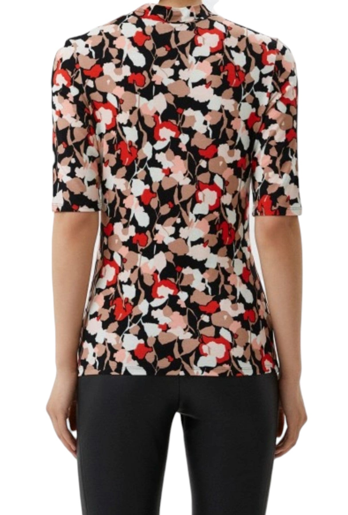 Floral patterned blouse worn by a person on a white background