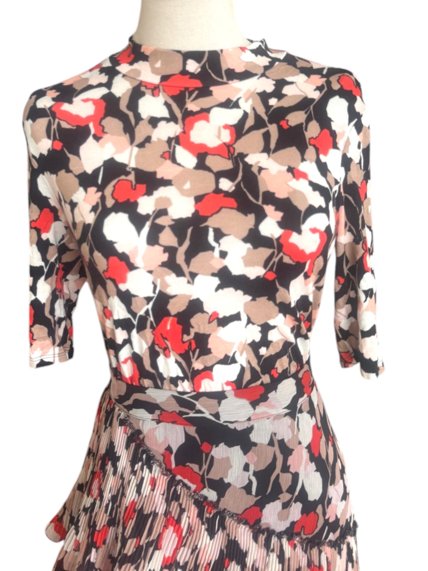Floral patterned dress on a mannequin against a white background