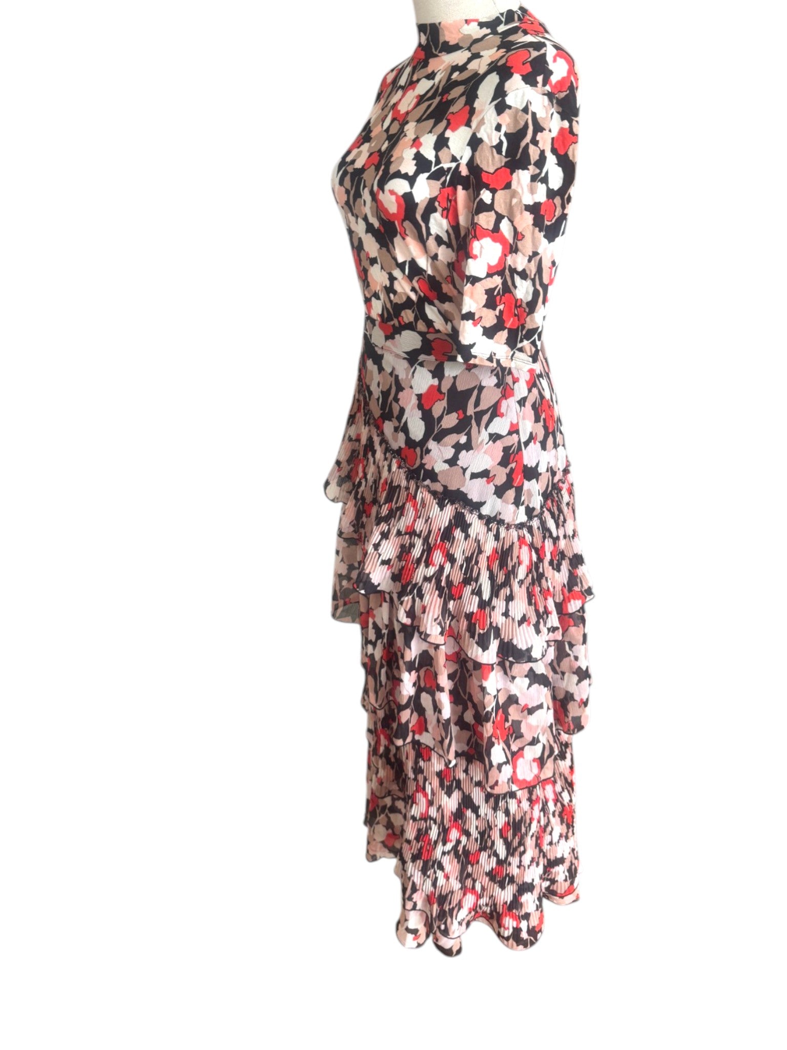 Floral patterned dress on a mannequin against a white background