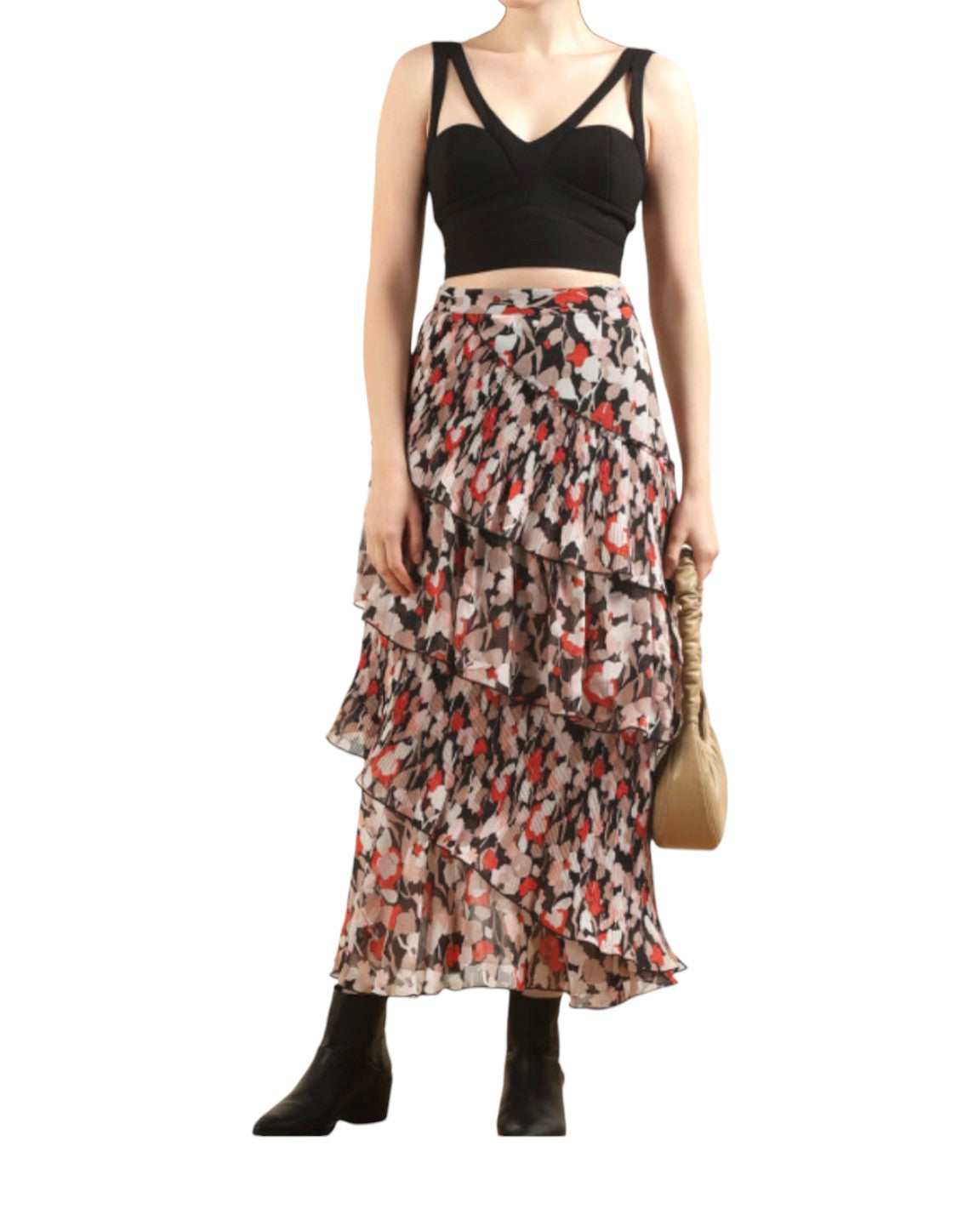 Person wearing a black top and patterned skirt on a white background