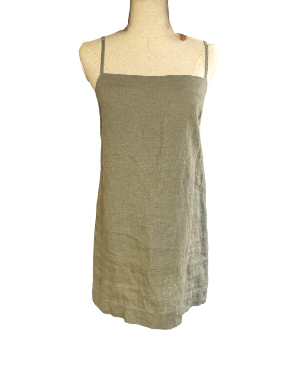 Green dress on a mannequin against a white background