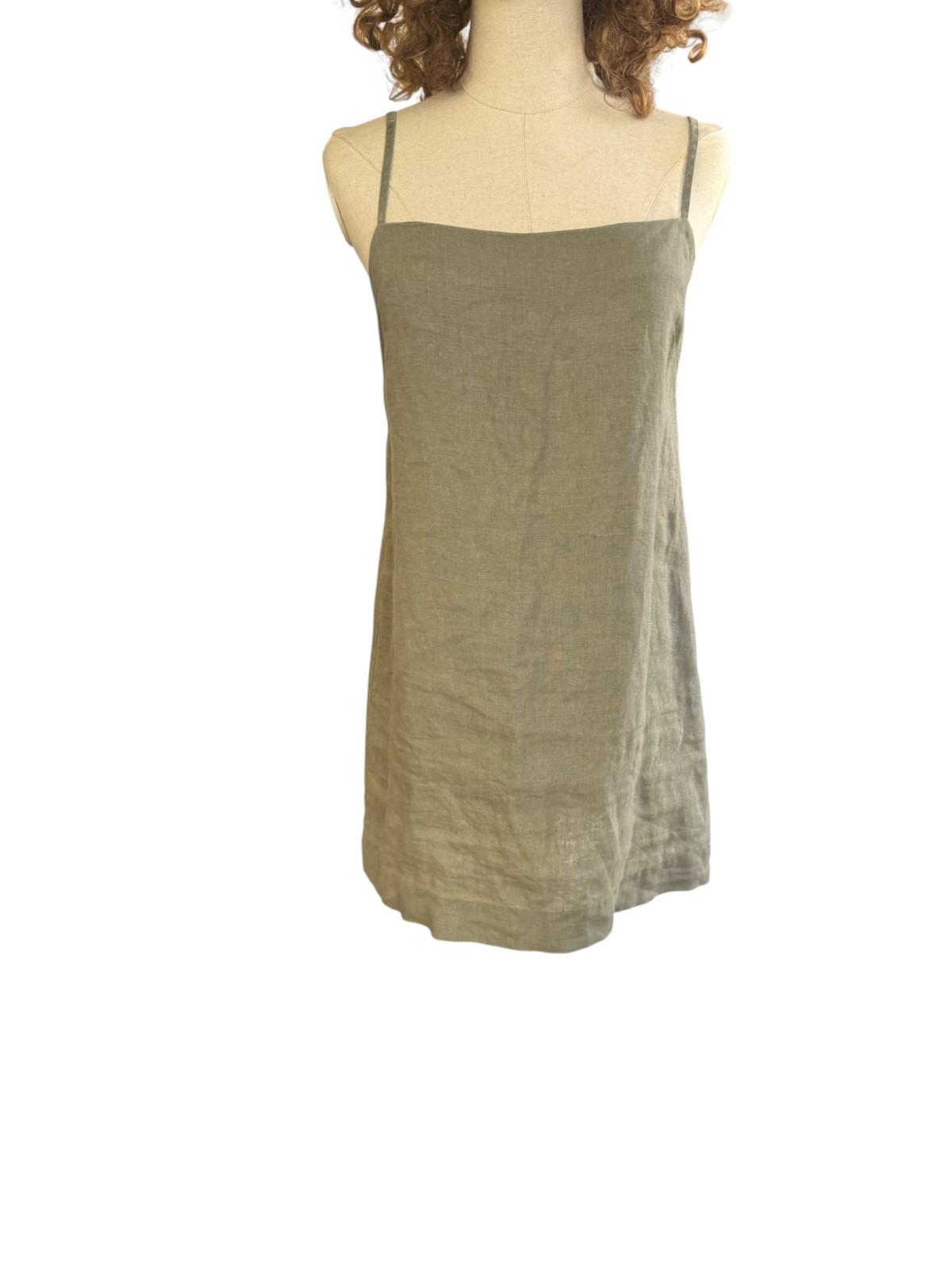 Green tank top on a mannequin against a white background