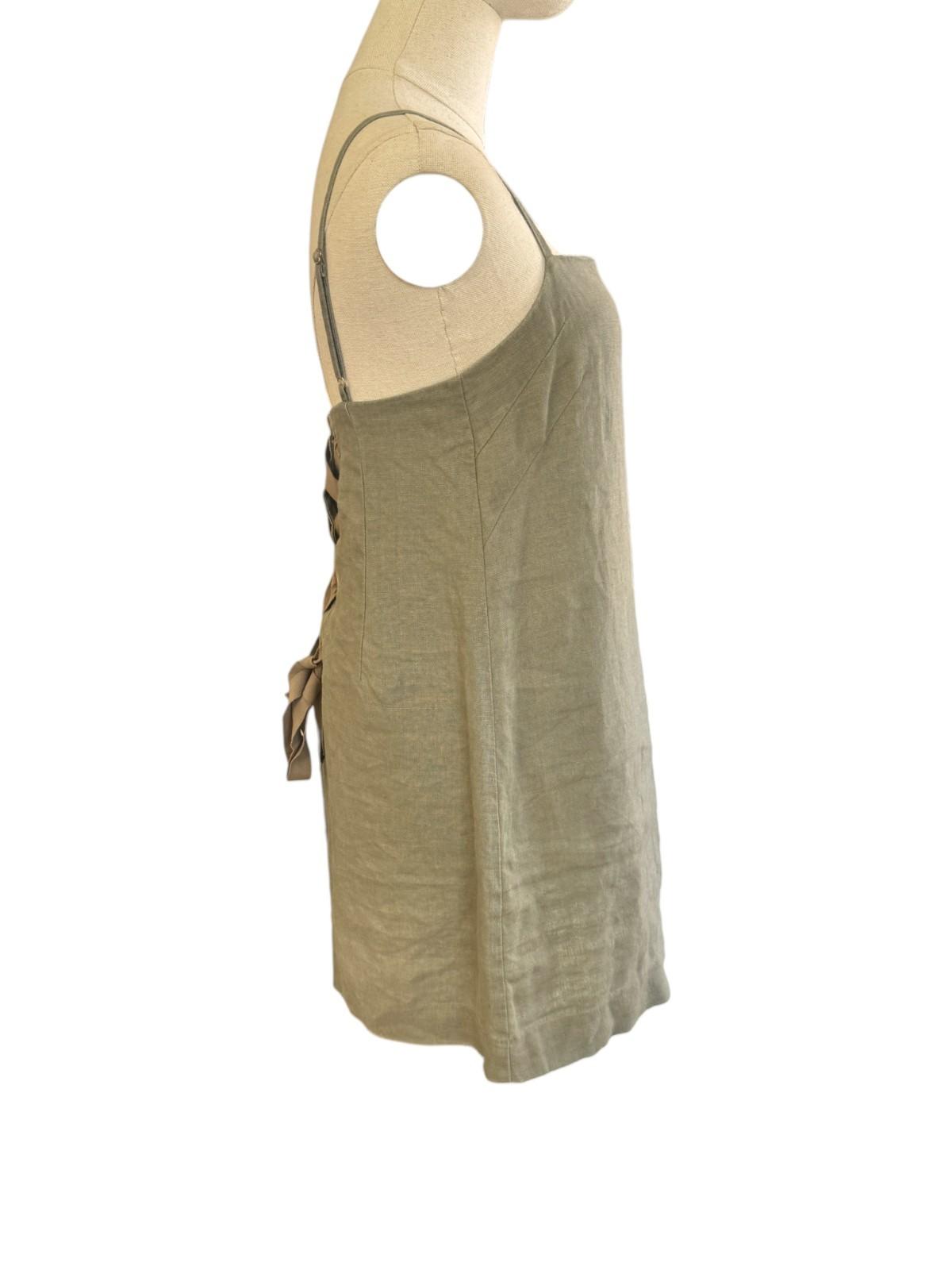 Beige sleeveless dress on a mannequin against a white background