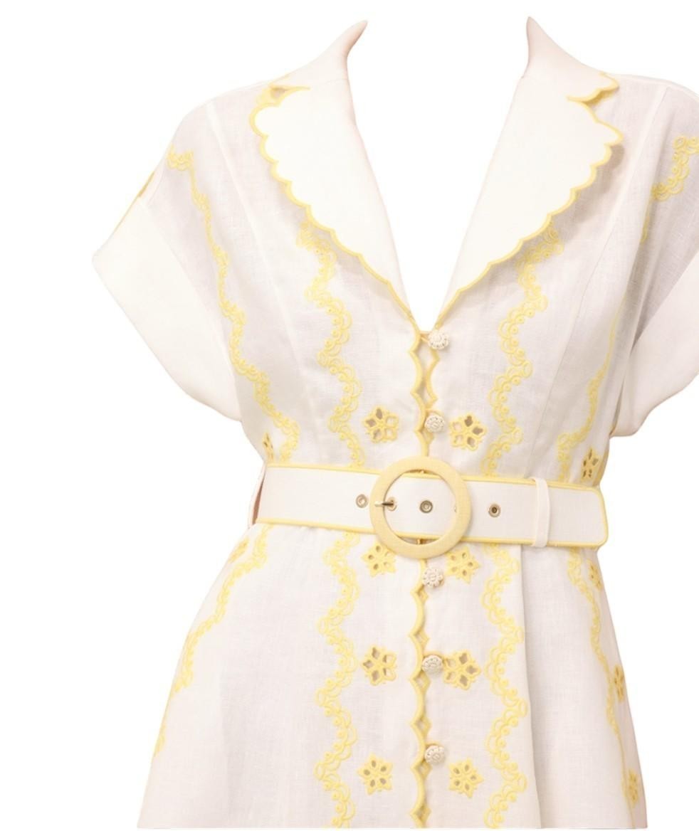 AI generated image of Naked Pear Zimmermann Lucky linen midi dress in ivory and lemon with scalloped collar, embroidery, and buckle belt.
