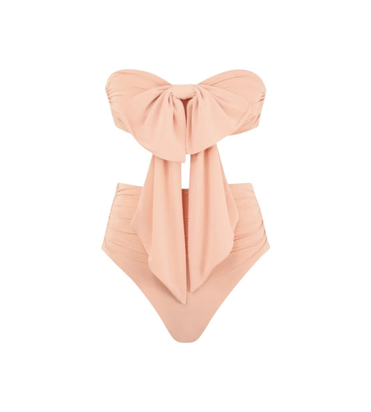 A peach-colored one-piece swimsuit with a large bow detail on the strapless bandeau top and a matching front drape, shown against a plain white background.