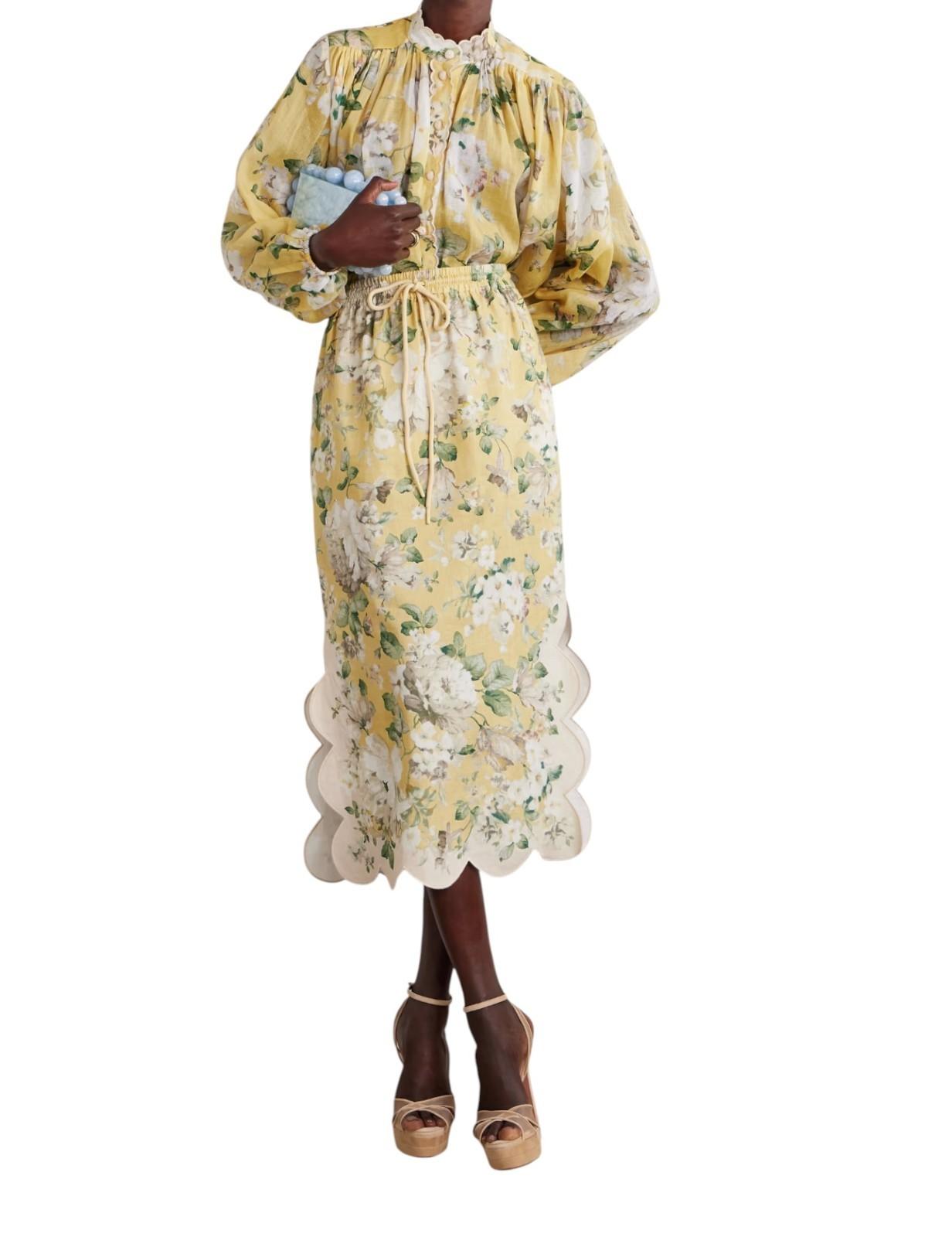Woman wearing a yellow floral dress on a white background