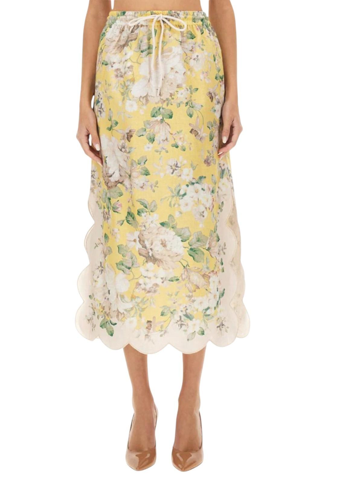 Yellow floral skirt worn by a person on a white background