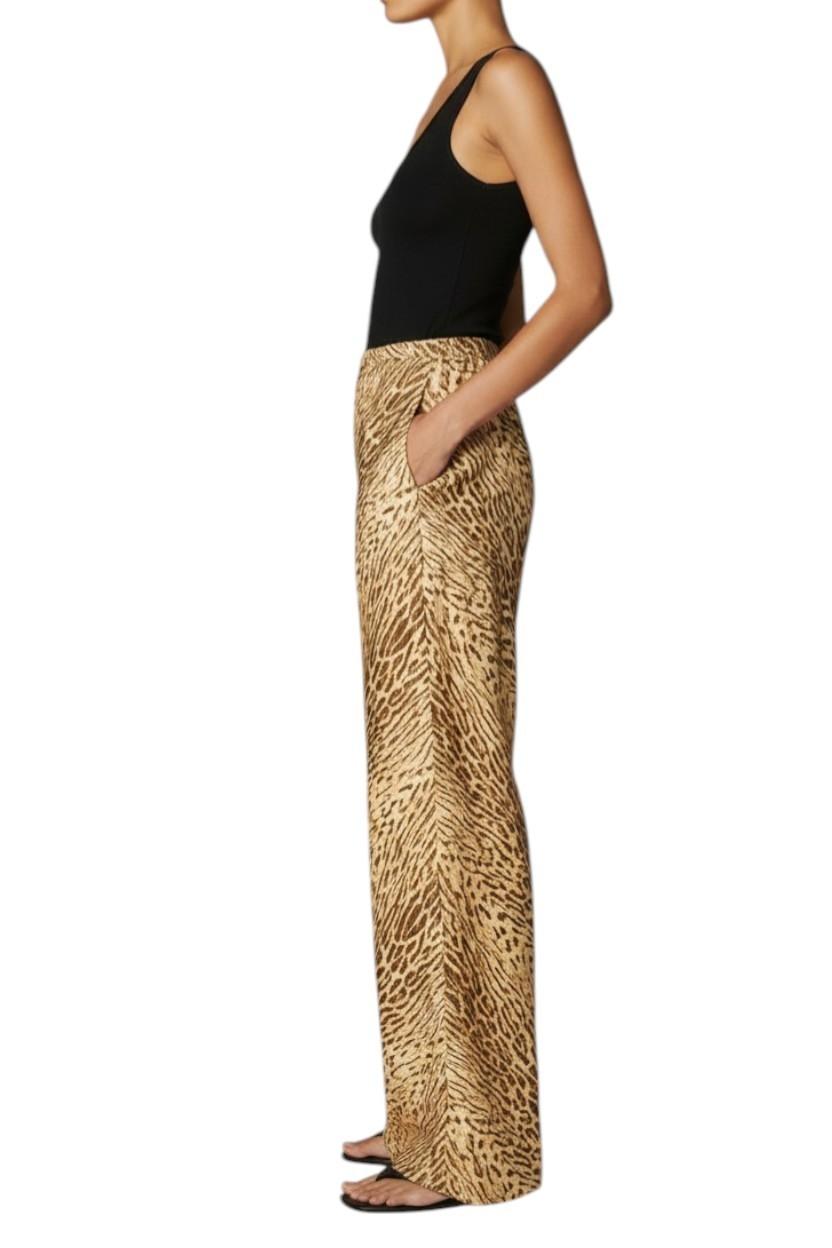 AI generated image of Woman wearing a black top and leopard print pants on a white background