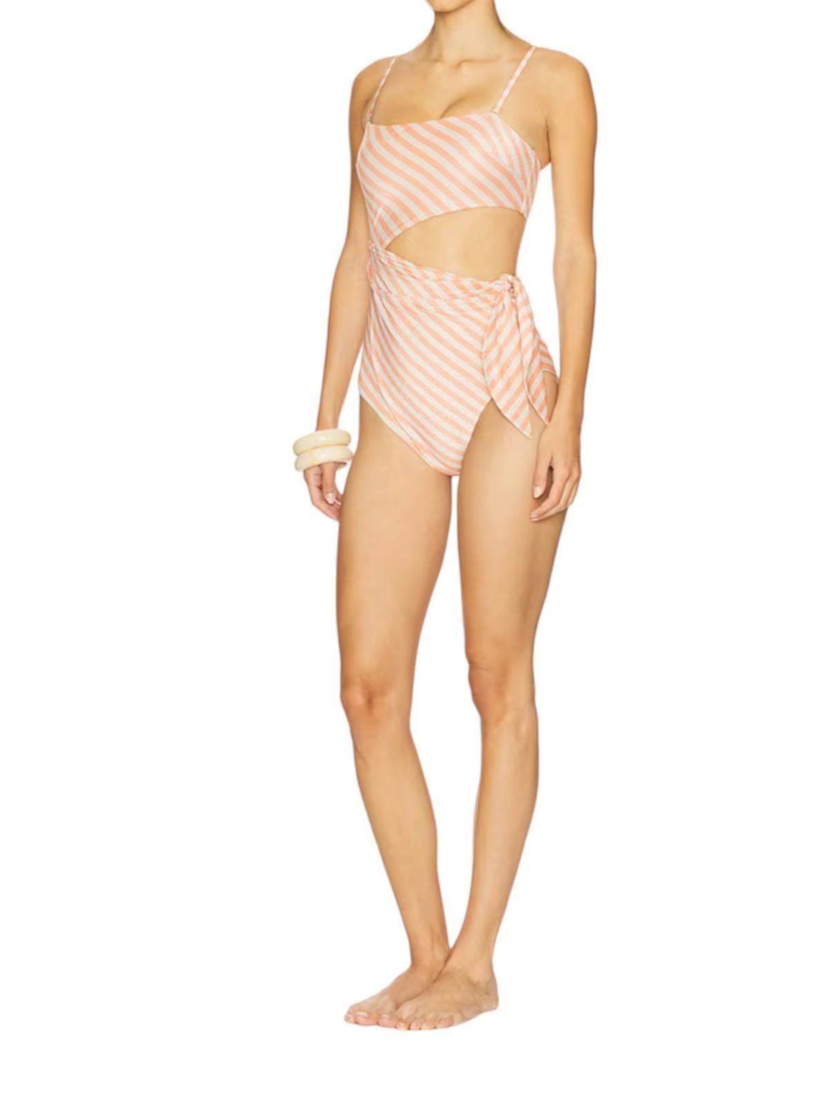 Woman wearing a pink and white striped swimsuit on a white background