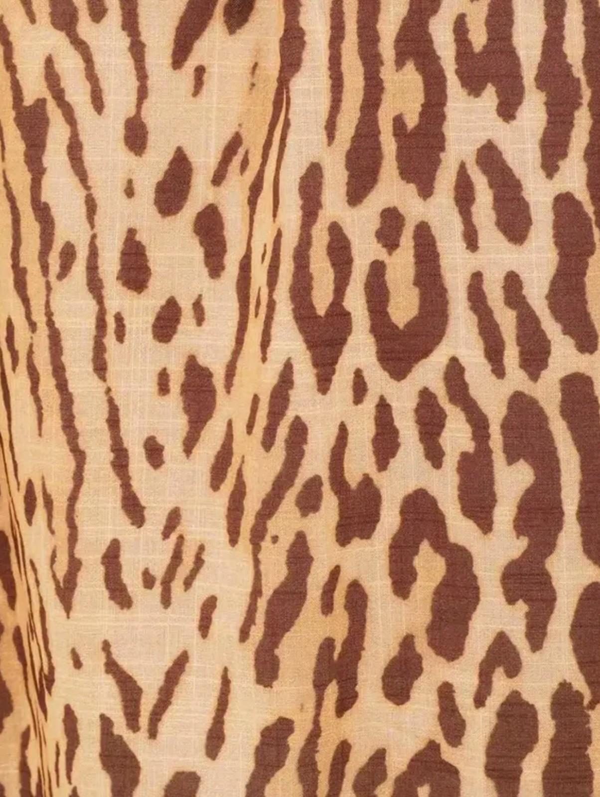Close-up of a fabric with a brown and beige leopard print pattern.