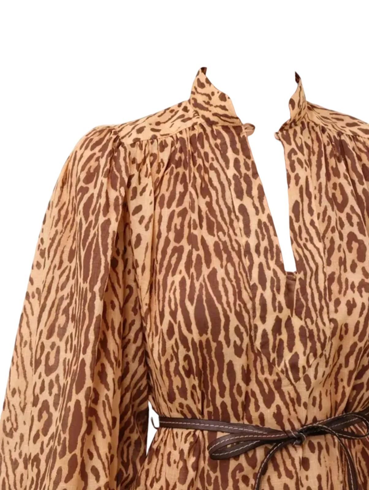Leopard print dress with long sleeves and a belt on a white background