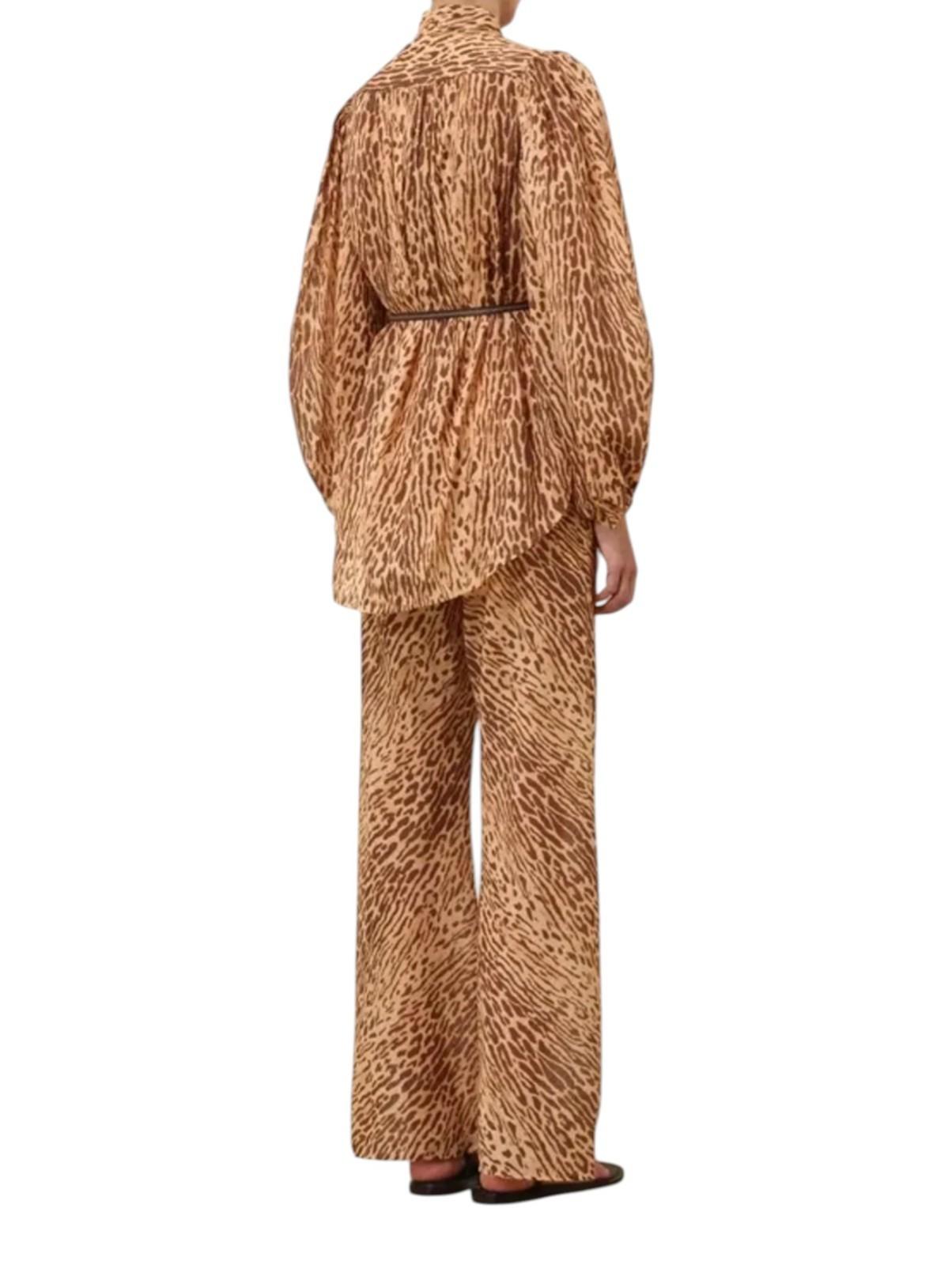 Person wearing a brown leopard print outfit on a white background