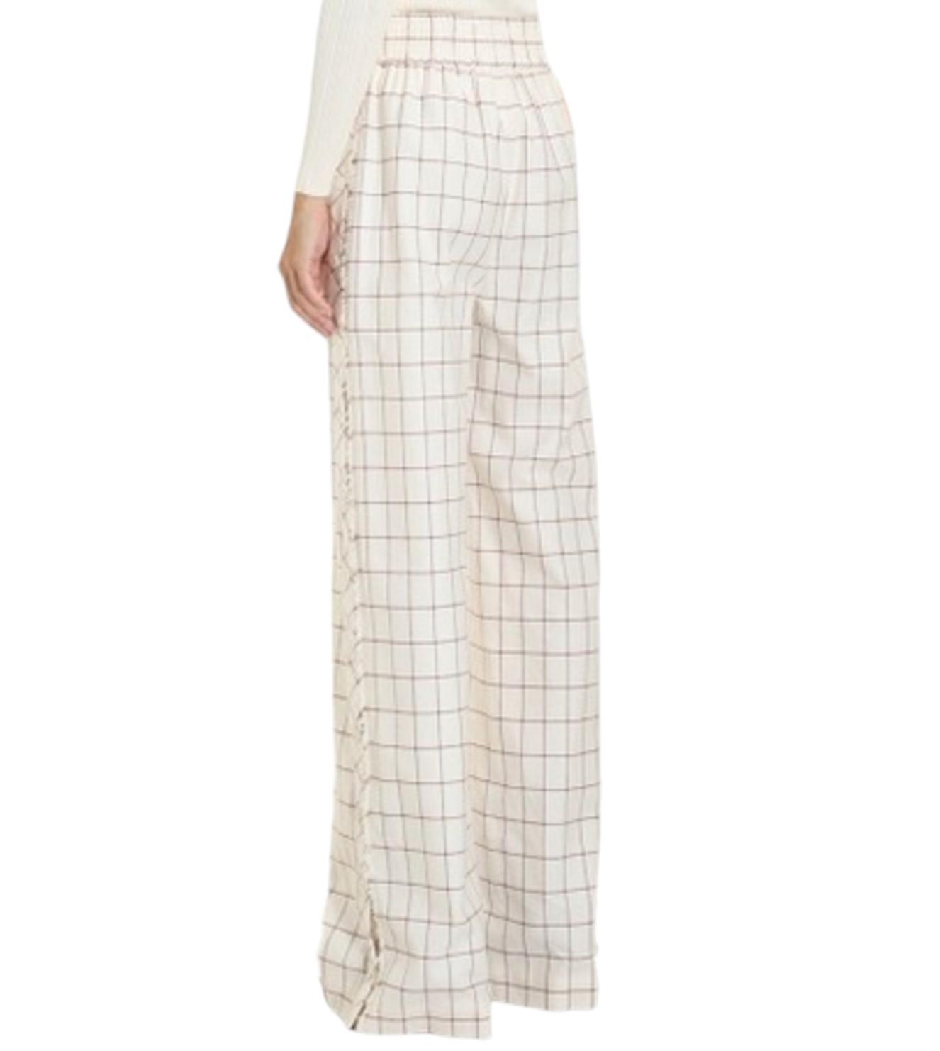 Plaid pants worn by a person on a white background
