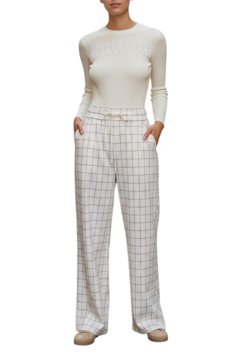 AI generated image of Person wearing a white long-sleeve top and checkered pants on a white background