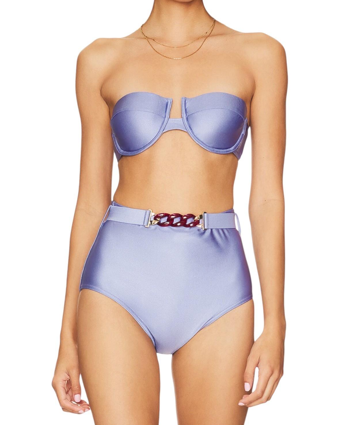 Woman wearing a light blue bikini with a belt on a white background