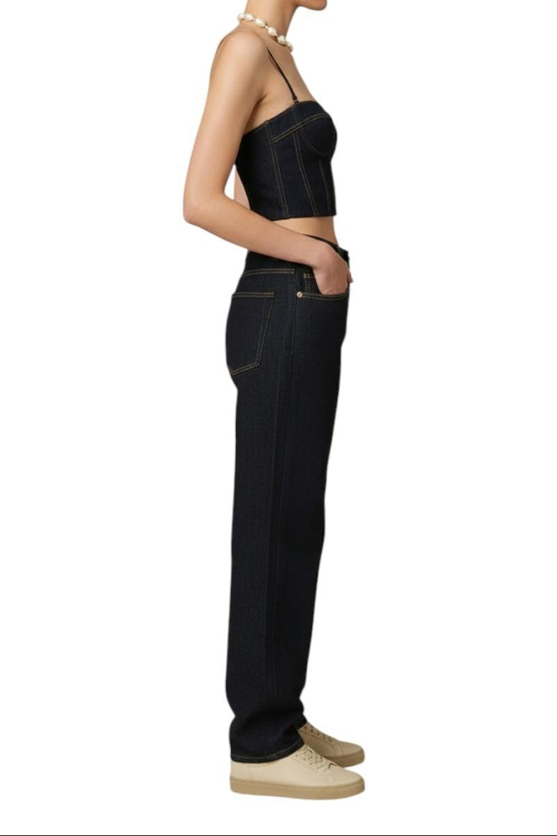 AI generated image of Person wearing a black strapless top and dark jeans on a white background