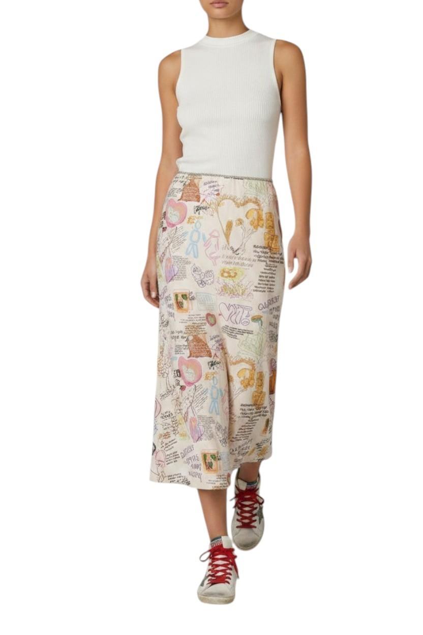 Person wearing a white sleeveless top and patterned skirt on a white background