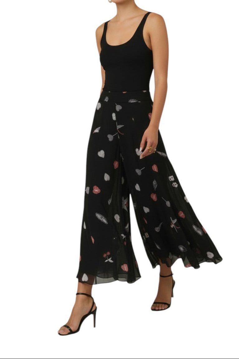 AI-generated image of Black jumpsuit with floral patterns worn by a model on a white background