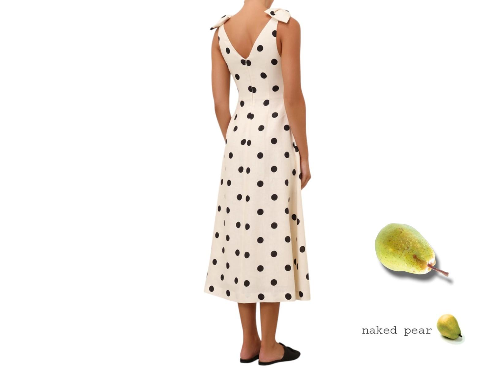 Woman wearing a polka dot dress with a naked pear graphic on a white background