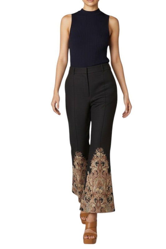 AI generated image of Woman wearing a sleeveless black top and black pants with floral embroidery on a white background