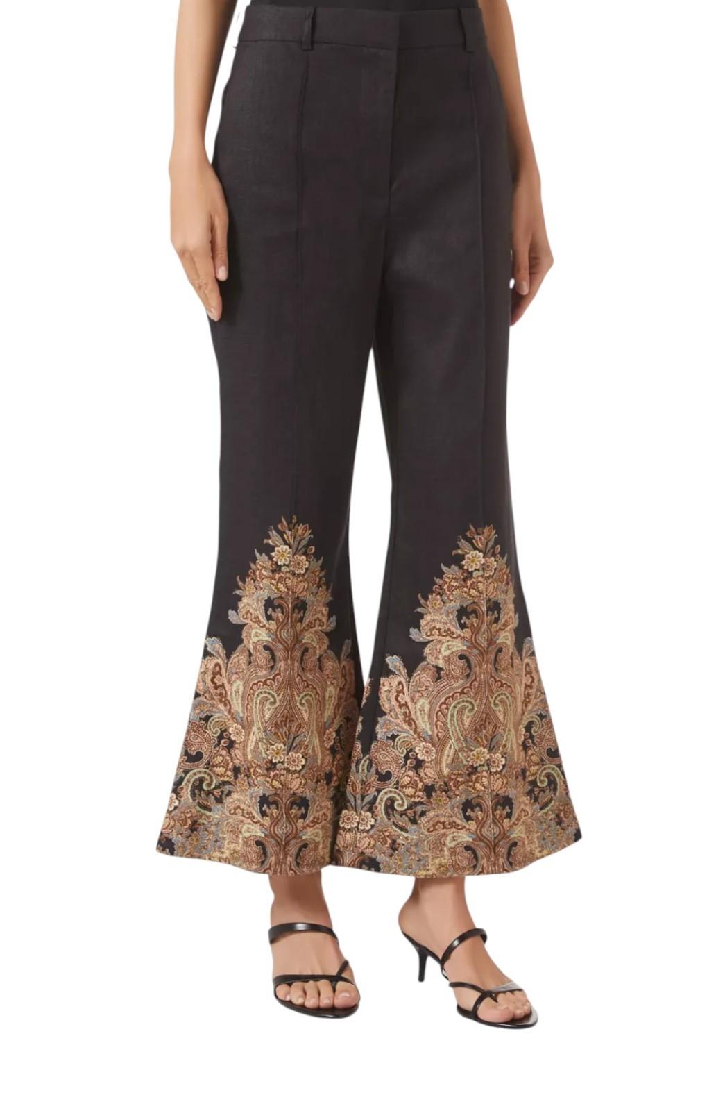 Black pants with intricate gold and brown patterns on a white background