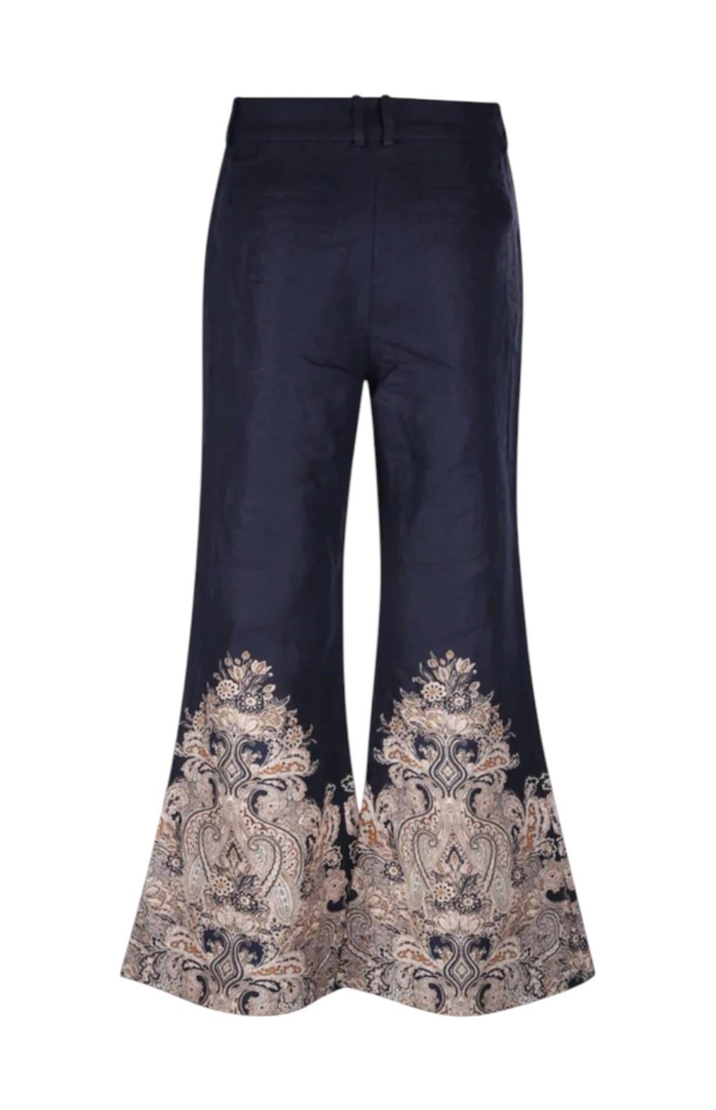 Navy blue pants with intricate gold embroidery on a white background