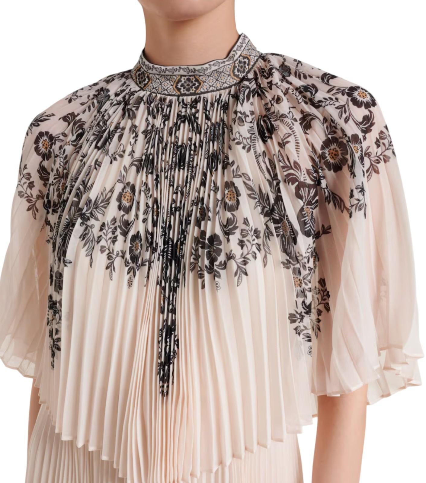 Floral embroidered blouse with pleated skirt on a white background