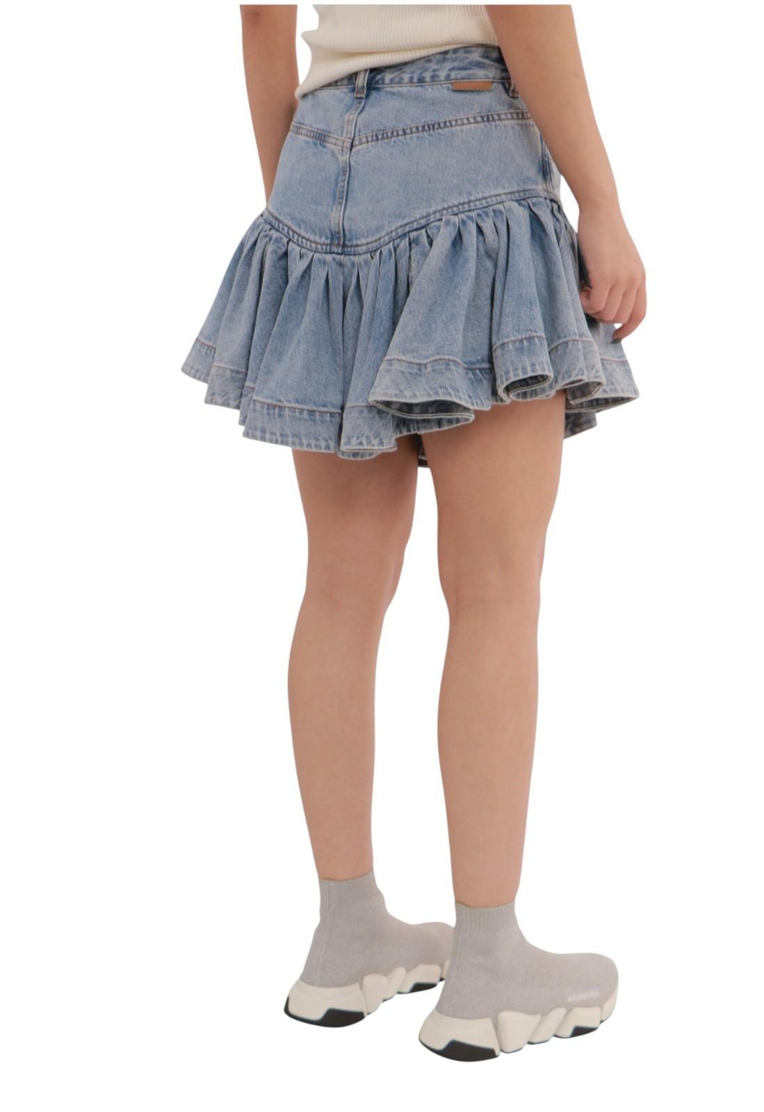 Denim skirt worn by a person on a white background