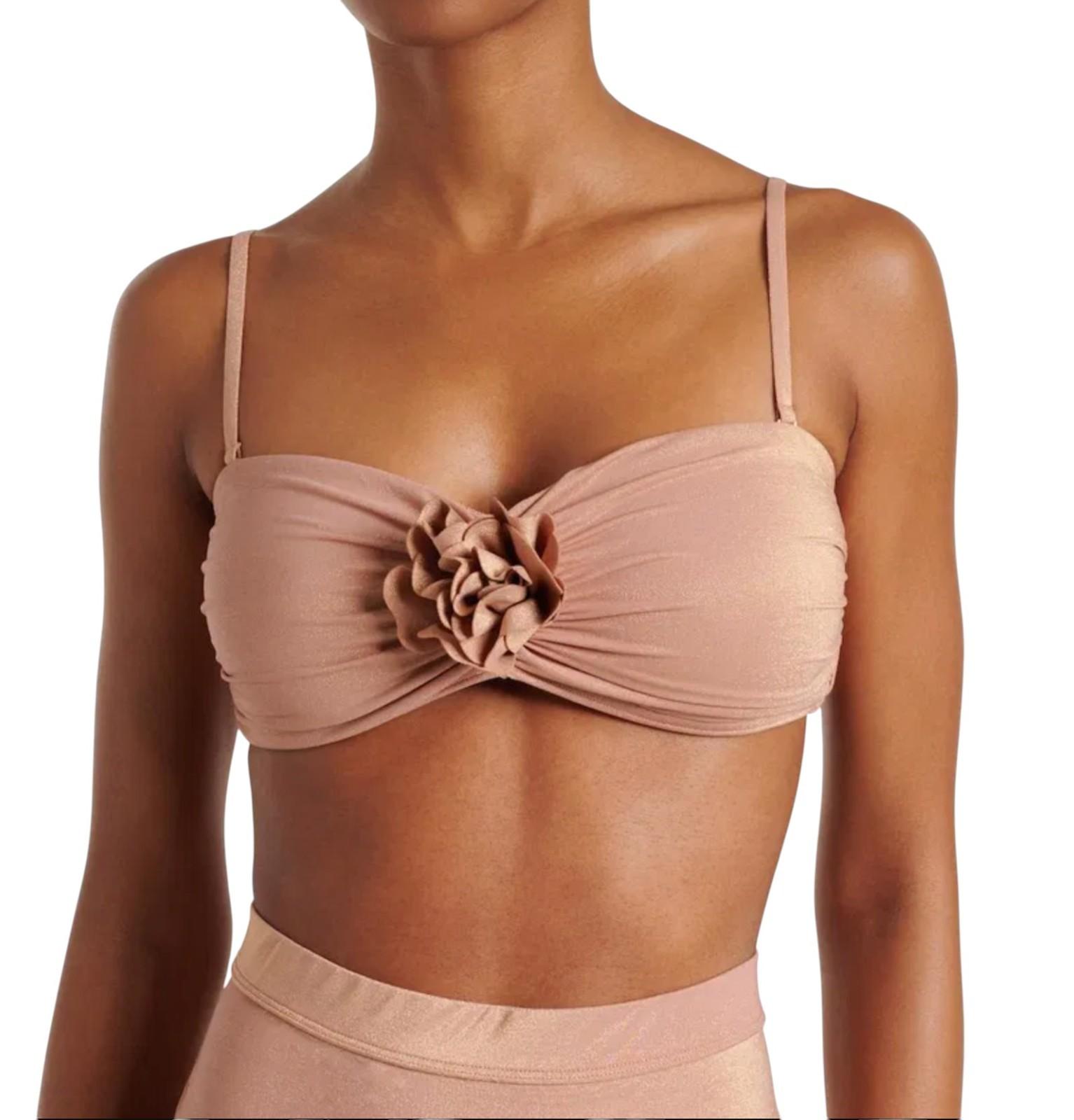 Beige bikini top with floral design on a white background