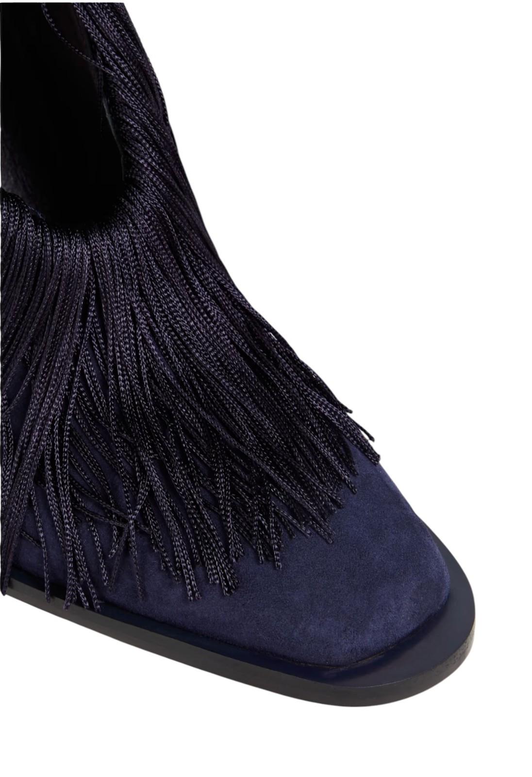 Navy blue boot with fringe details on a white background