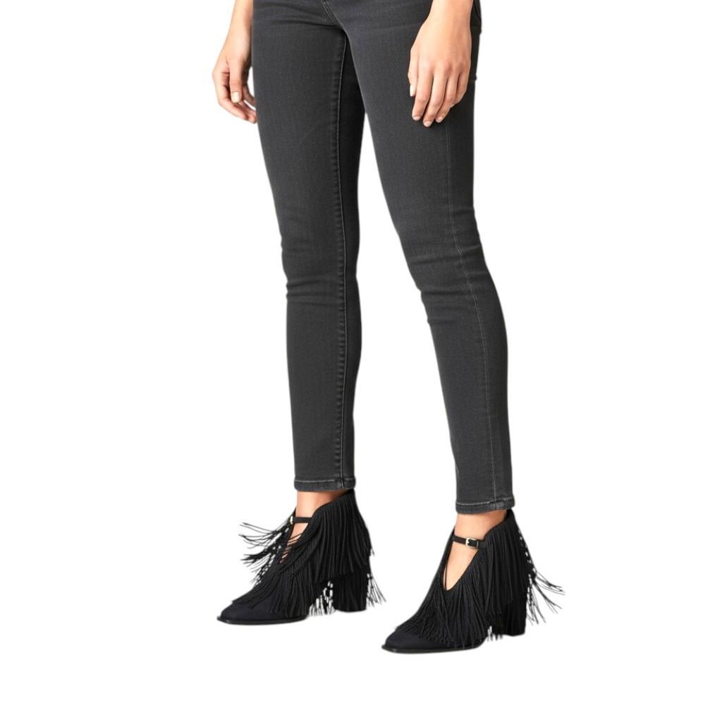 AI generated image of Person wearing black fringed ankle boots with gray jeans on a white background