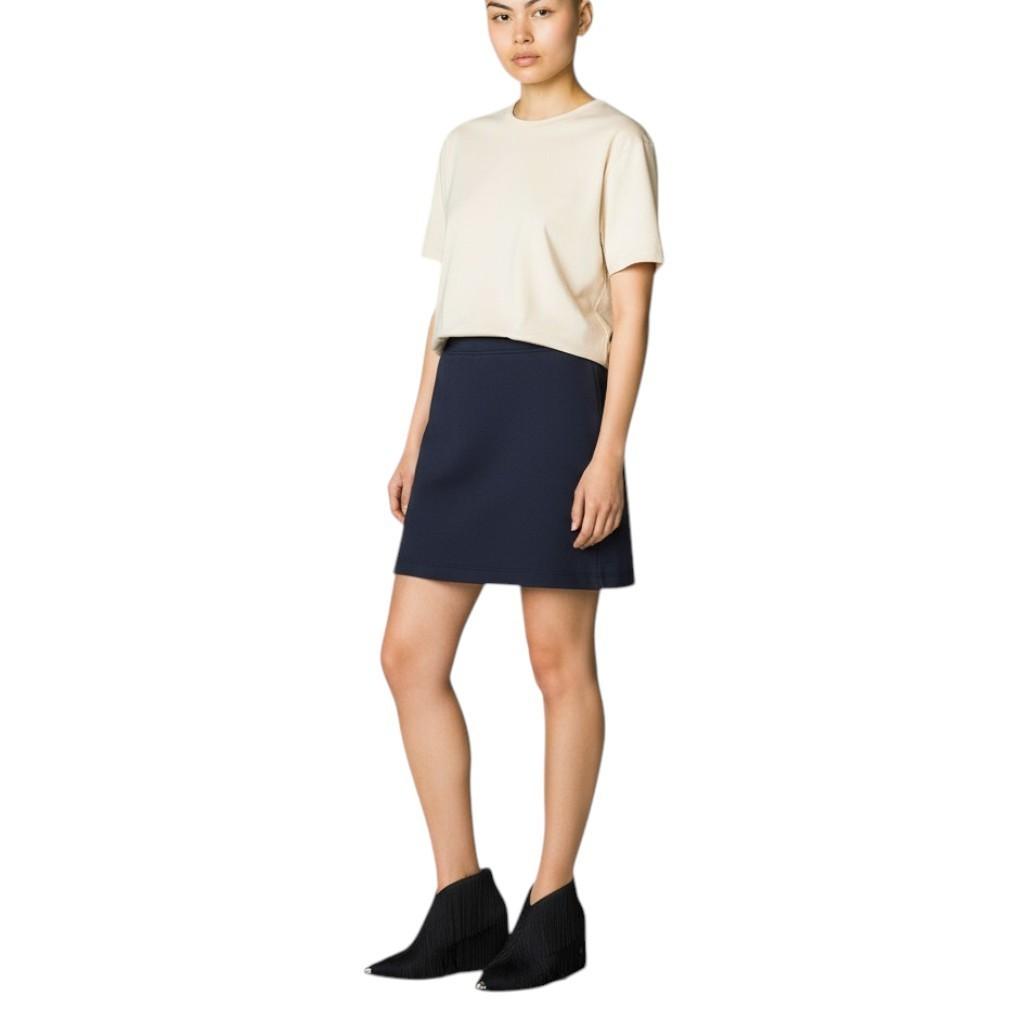 AI generated image of Woman wearing a beige top and navy skirt on a white background