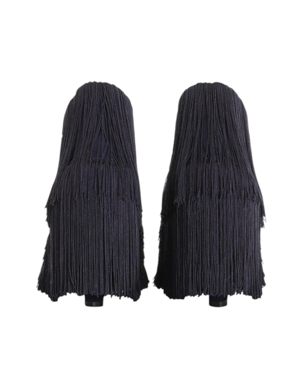 Two black fringed items on a white background