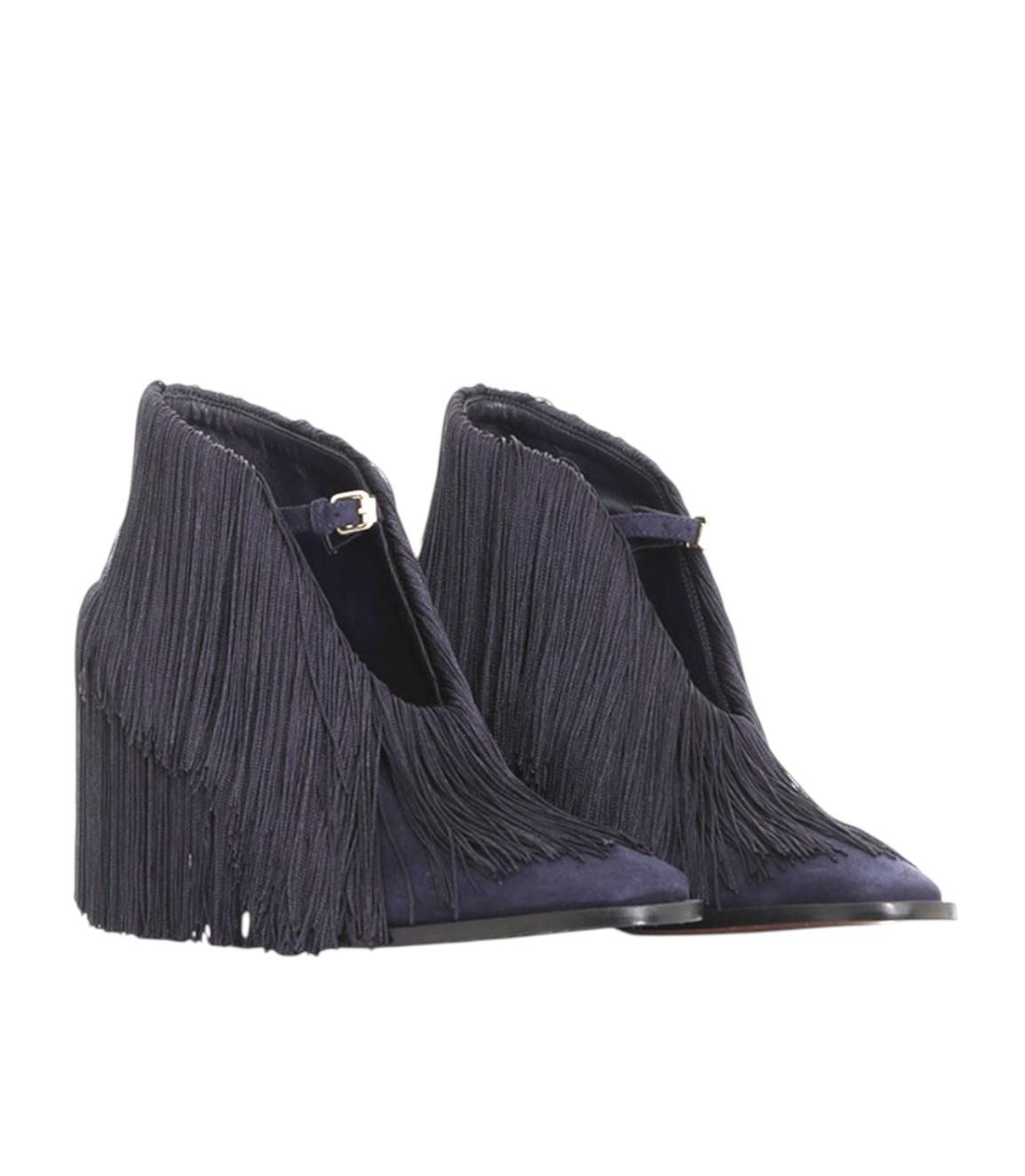 Pair of navy blue fringe ankle boots on a white background