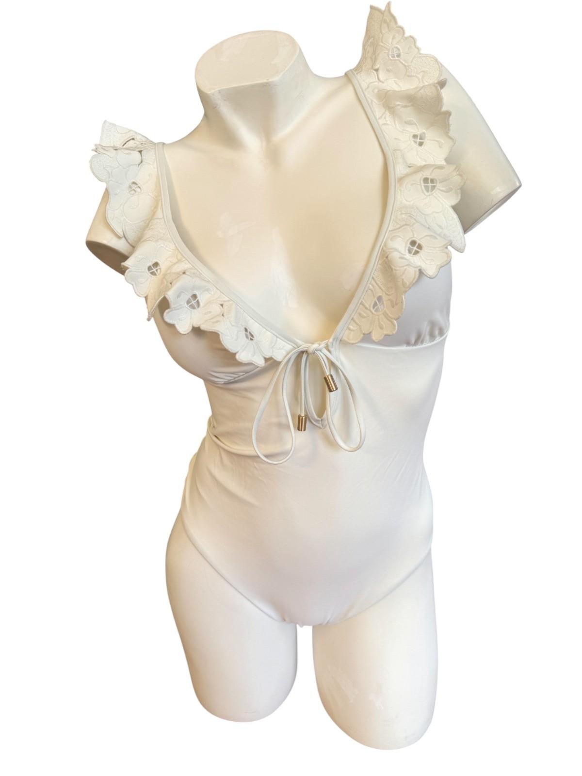 Beige lingerie set with ruffled details on a mannequin against a white background