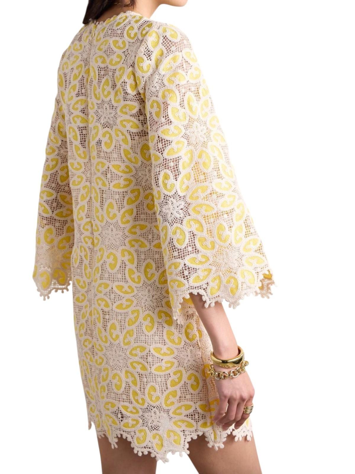 Yellow and white patterned dress with long sleeves on a white background