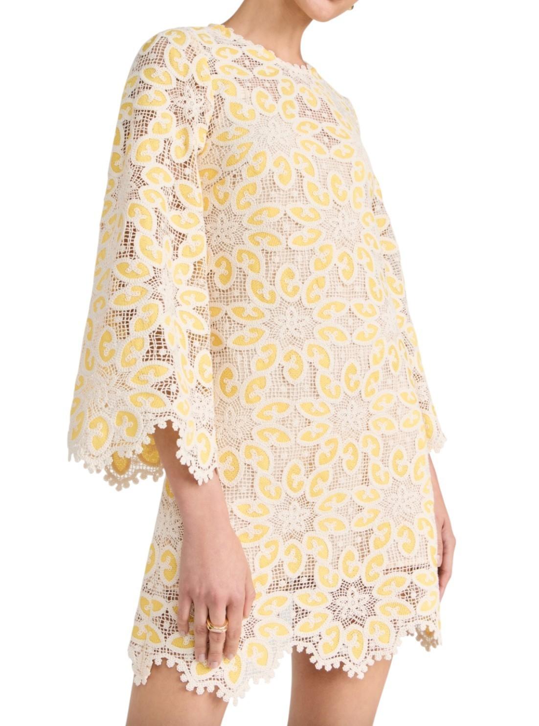Yellow lace dress with floral patterns on a white background